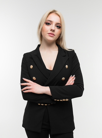 Charming blonde woman in black outfit posing on background